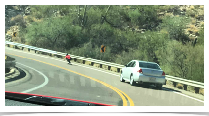 Very interesting  a skateboarder going down the highway